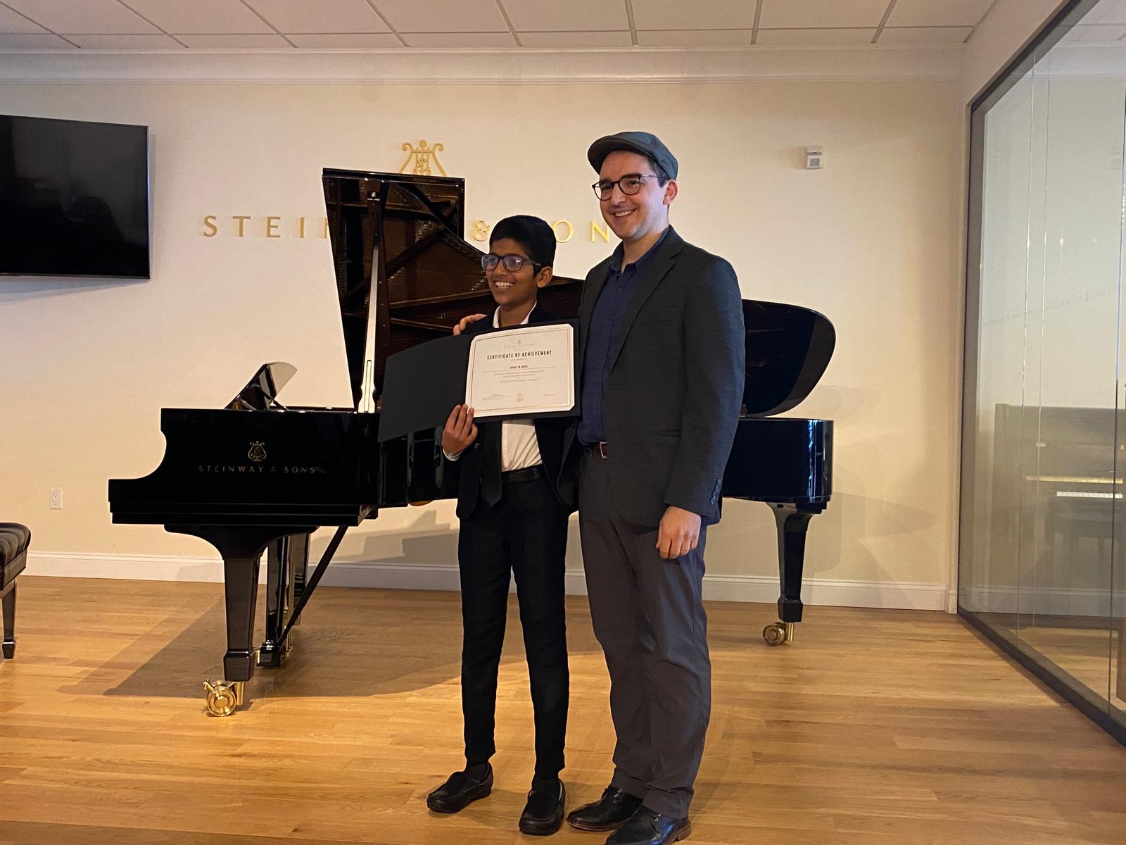 Student receiving a Steinway certificate